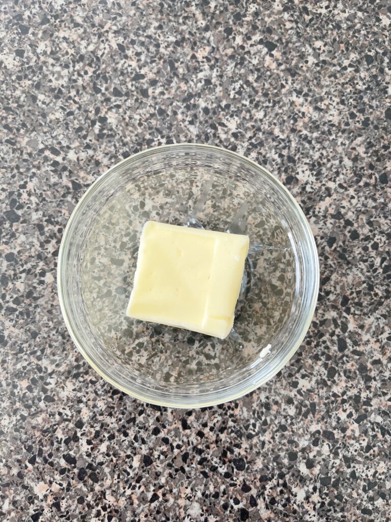 Two tablespoons of butter in a bowl.