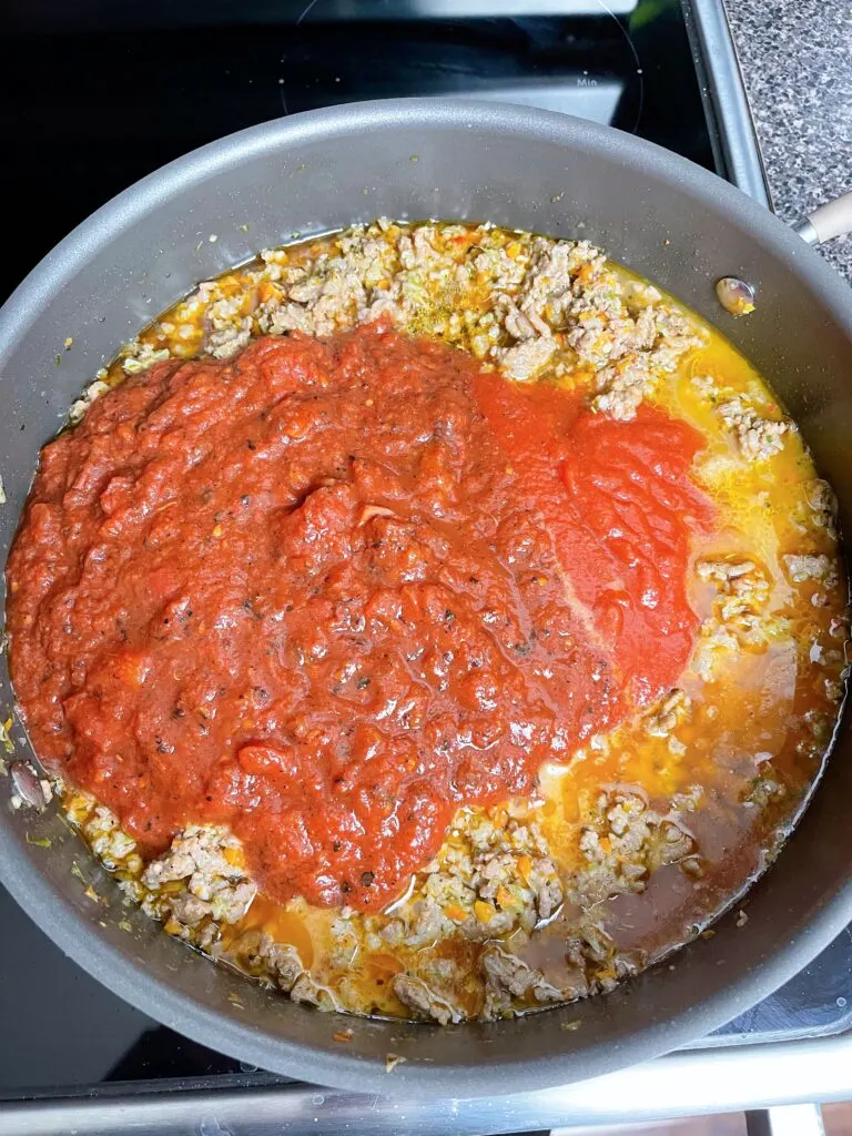 Crushed tomatoes, tomato sauce, and tomato paste added to spaghetti sauce.