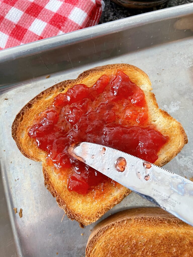 Strawberry jam on oven toast.