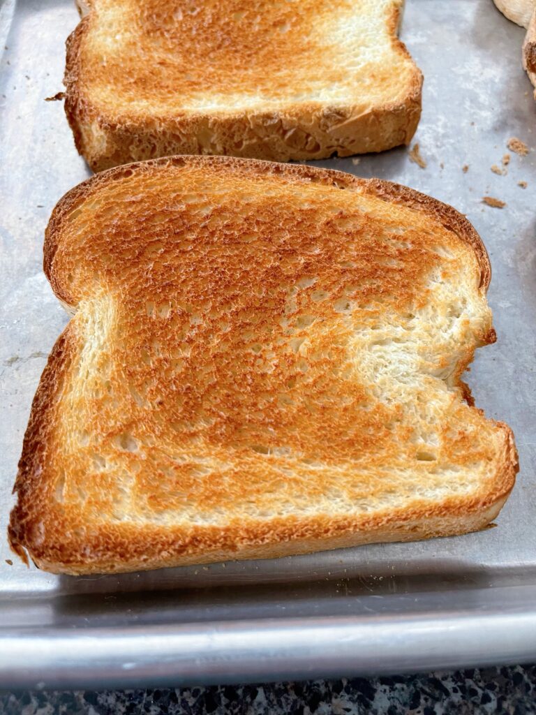 A slice of bread that was toasted in the oven.