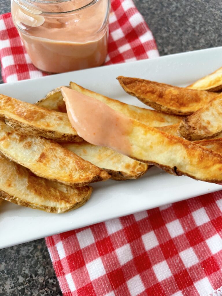 Potato wedges and fry dipping sauce.