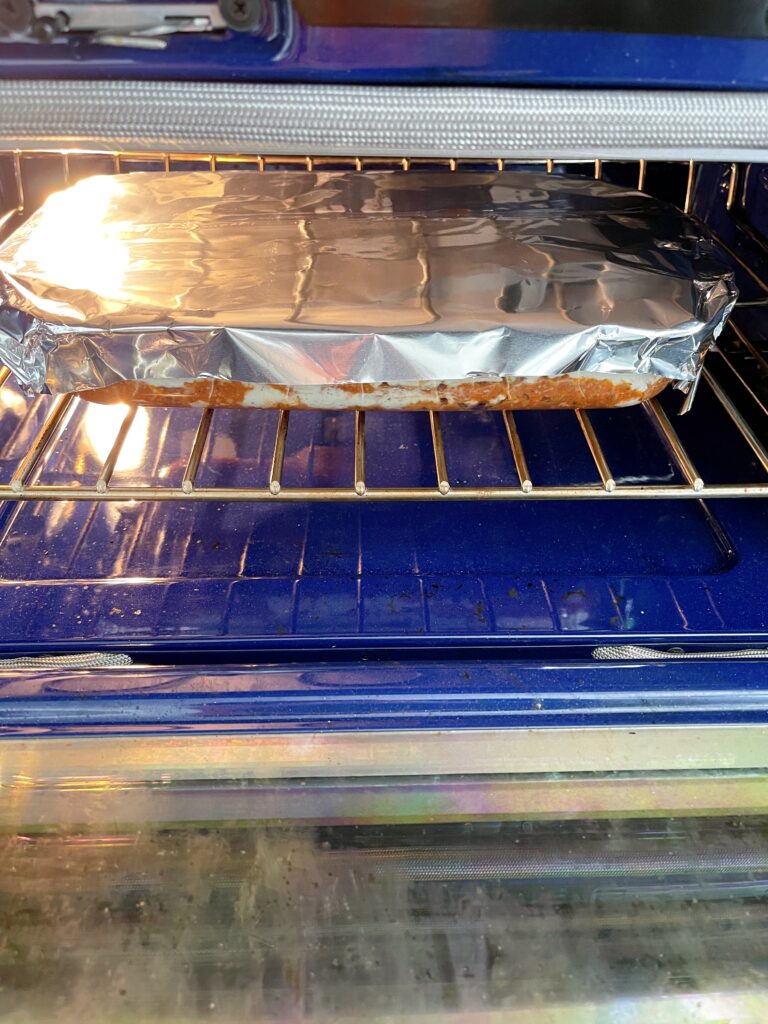 A pan of ricotta lasagna in the oven.