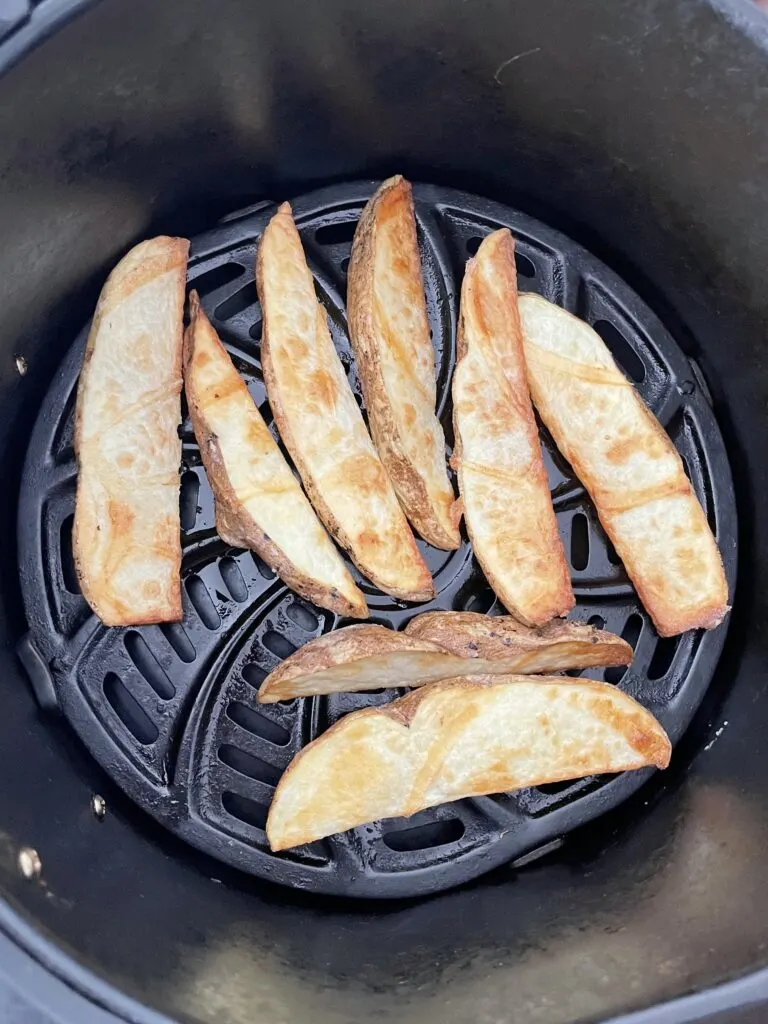 Potato wedges in an air fryer.