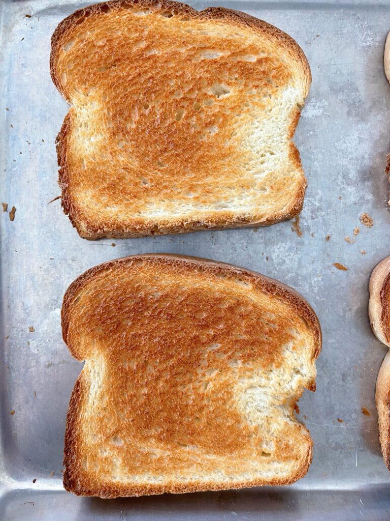 Oven toasted bread on a cookie sheet.