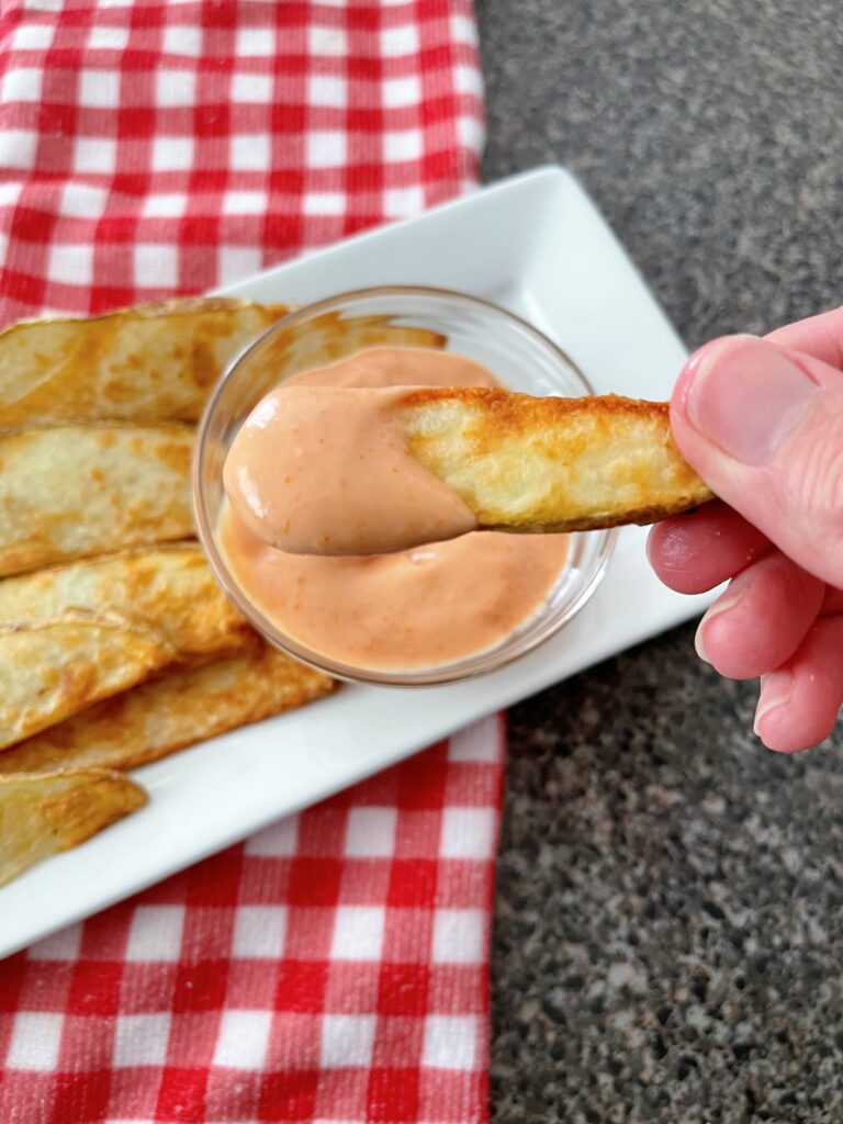 A fry dipped in fry sauce.