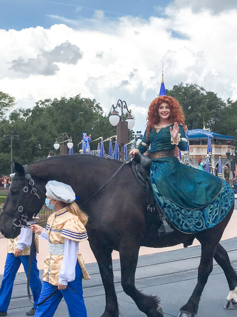 Princess Merida on a horse in a parade at Magic Kingdom.