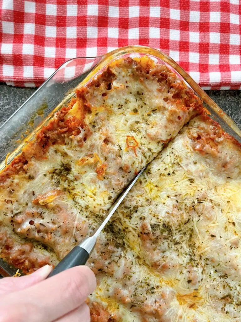 A pan full of lasagna made with ricotta cheese.