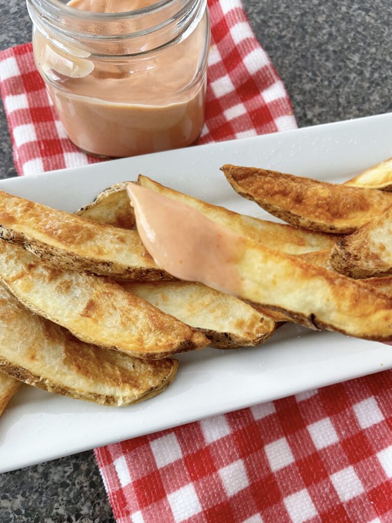 Potato wedges and fry dipping sauce.