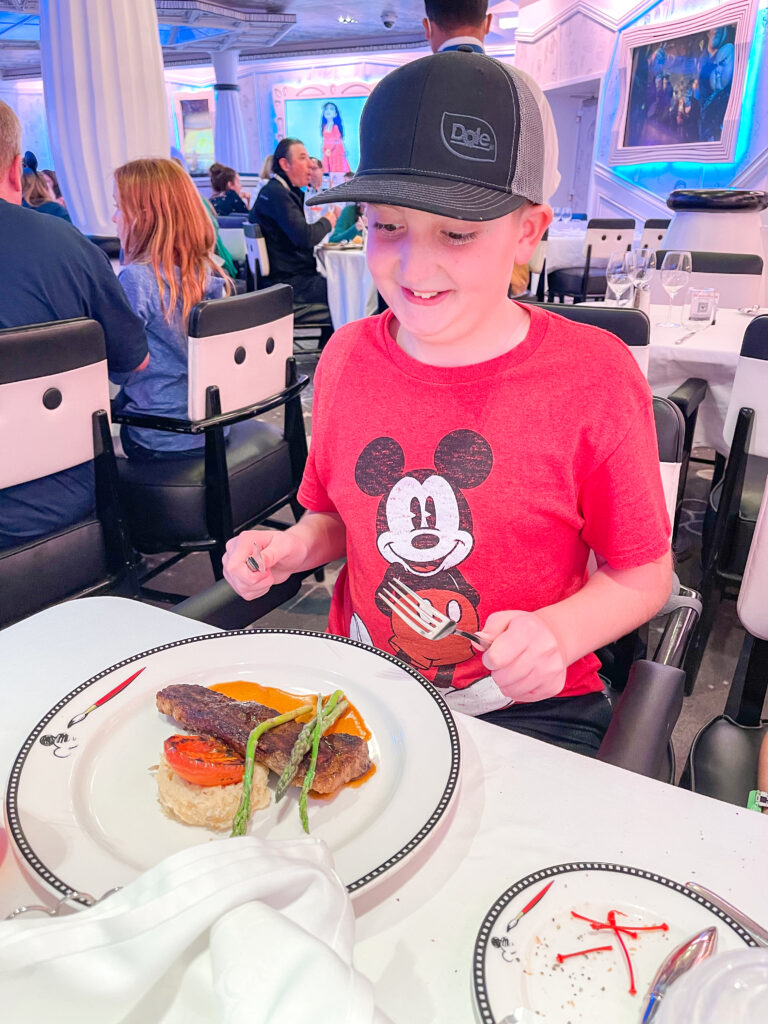 A boy eating a steak at Animator's Palate.