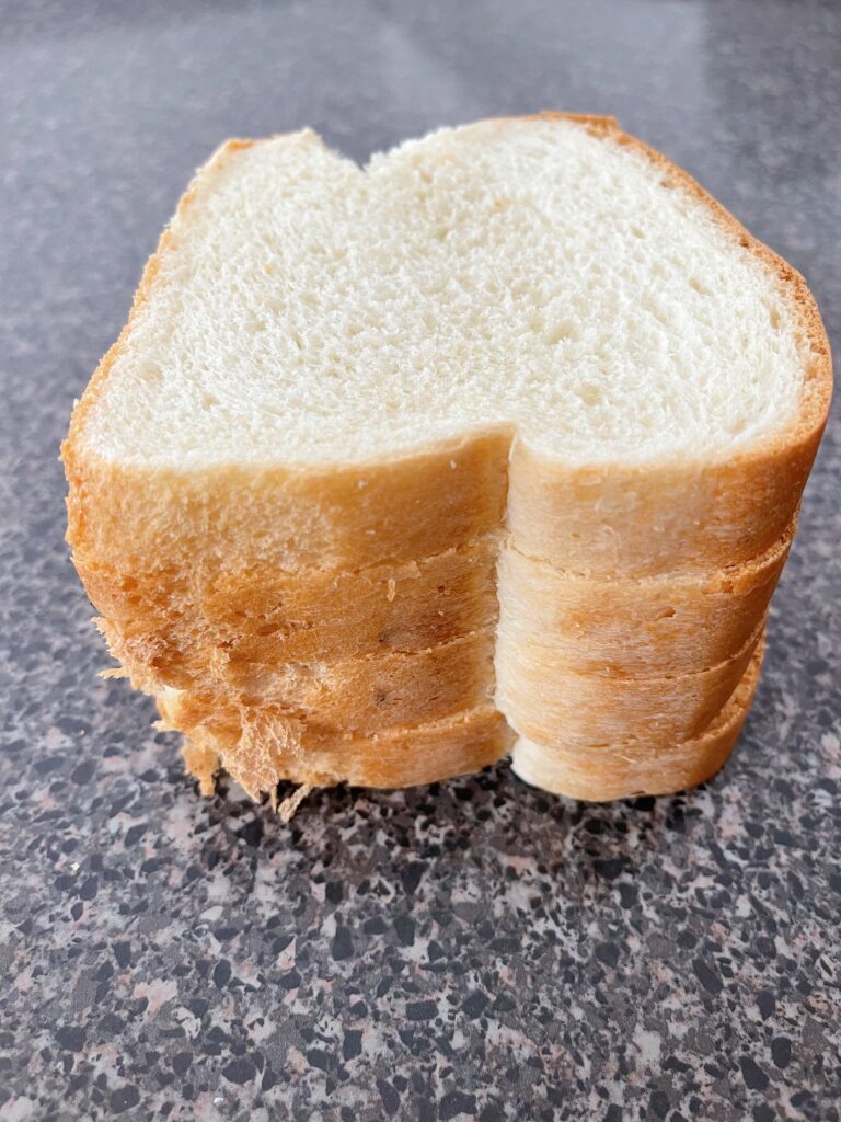 Four slices of bread stacked on top of each other.