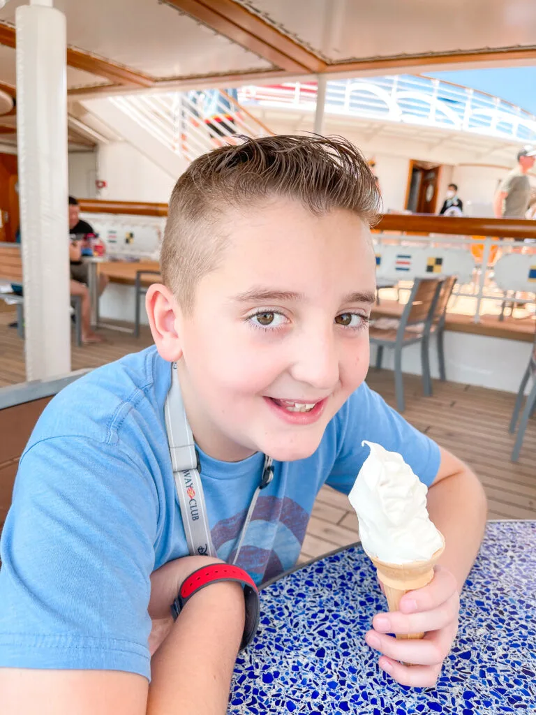 A boy enjoying an ice cream cone on a Disney Cruise.