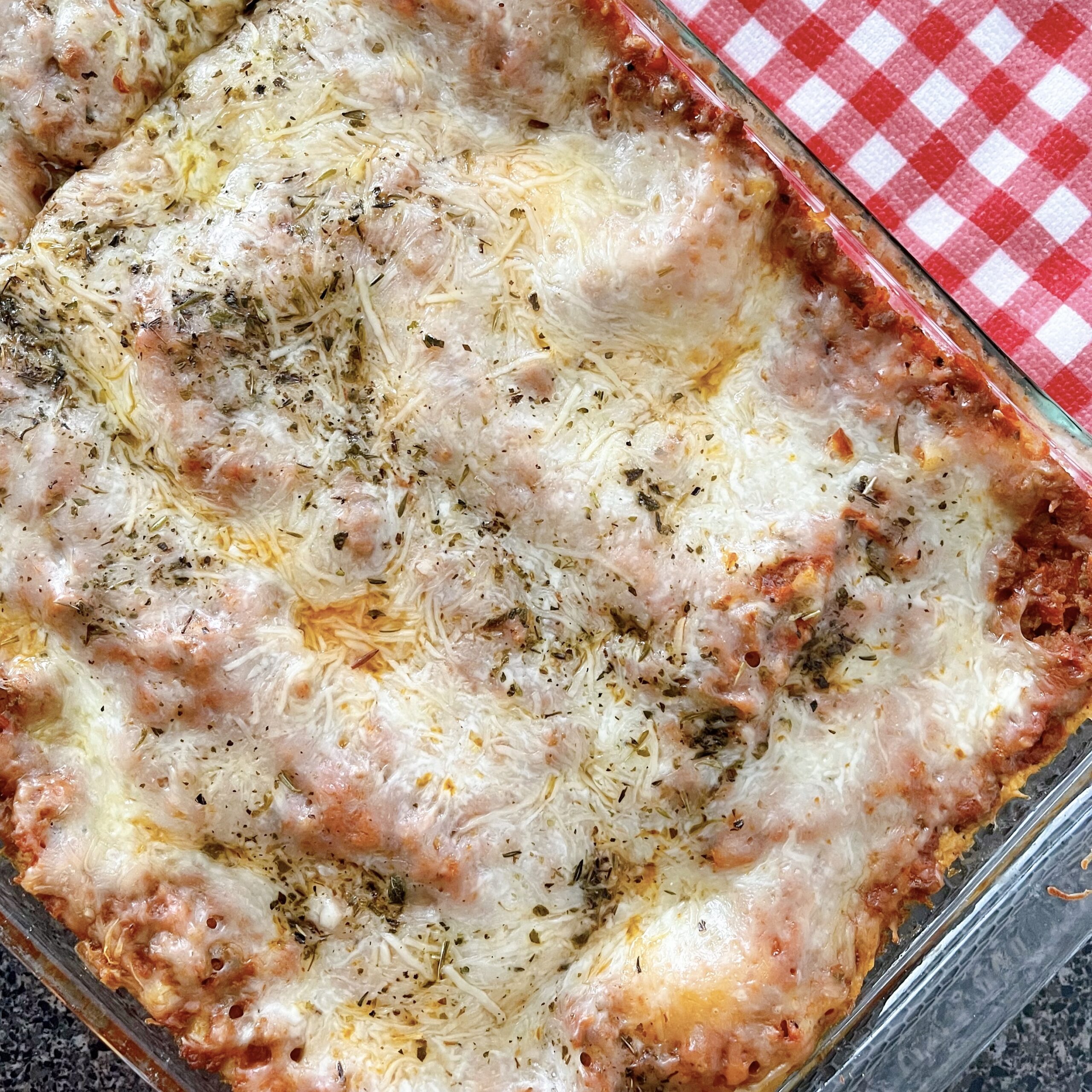 A pan full of lasagna made with ricotta cheese.