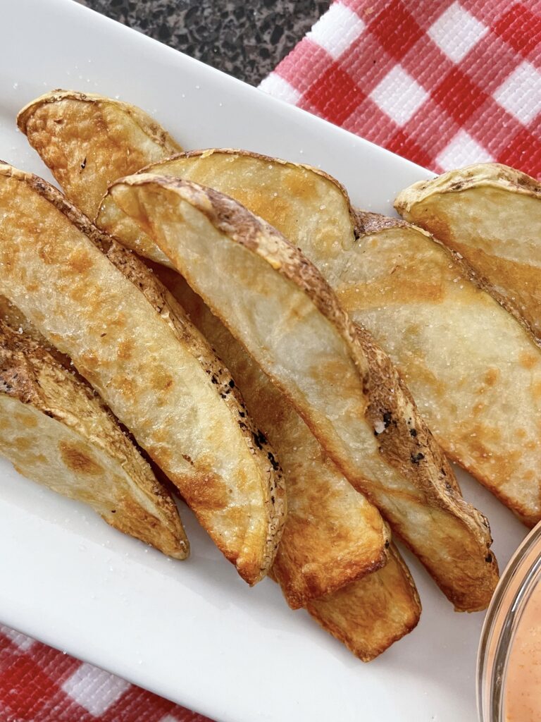 Potato wedges on a plate.