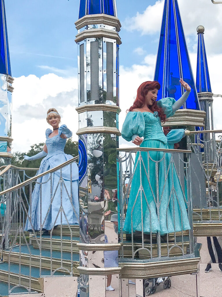 Cinderella and Ariel on a parade float at Disney World.