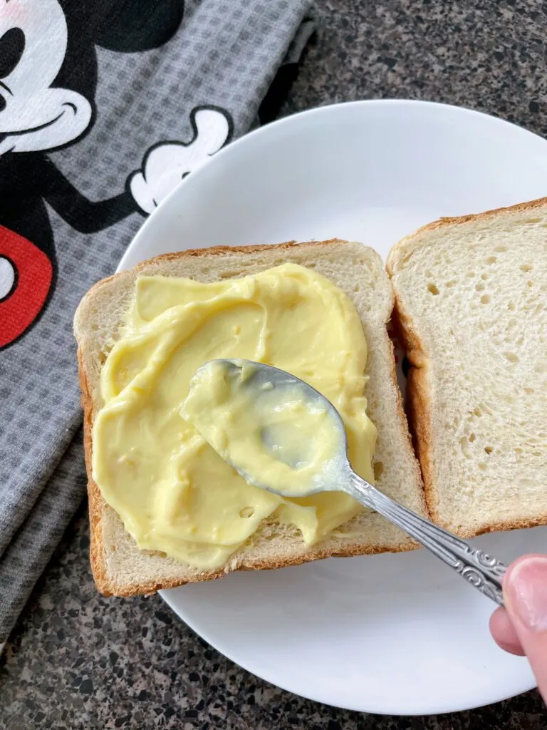 Lemon custard spread on bread to make Disneyland Hotel French Toast,