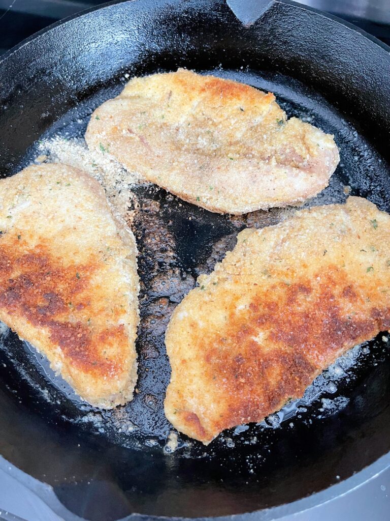 Chicken cooking in a skillet.