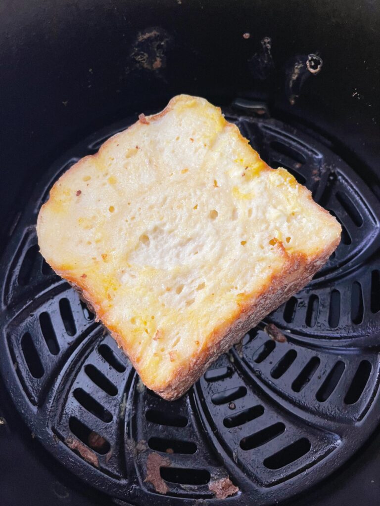 Crispy French Toast in an air fryer basket.