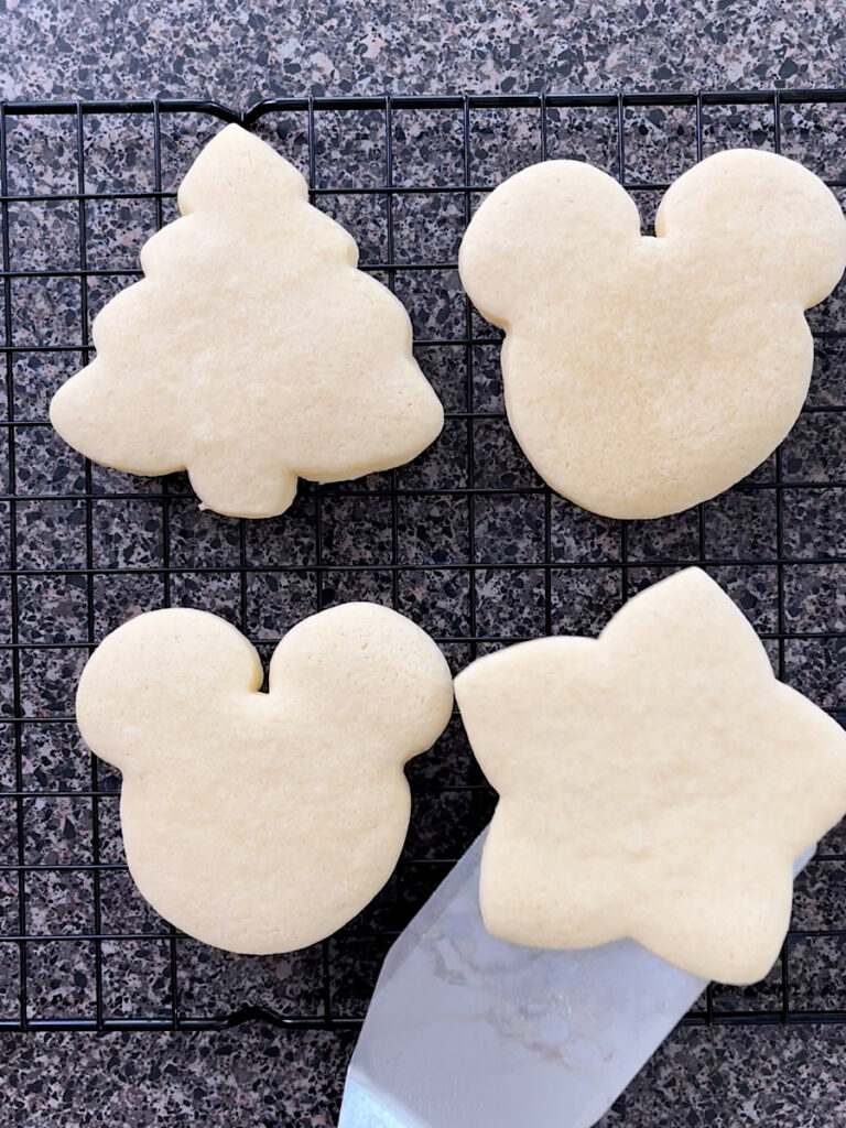 Sugar cookies on a wire rack.