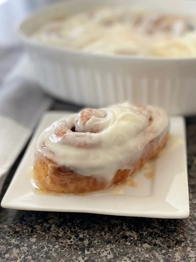 A TikTok cinnamon roll on a white plate.