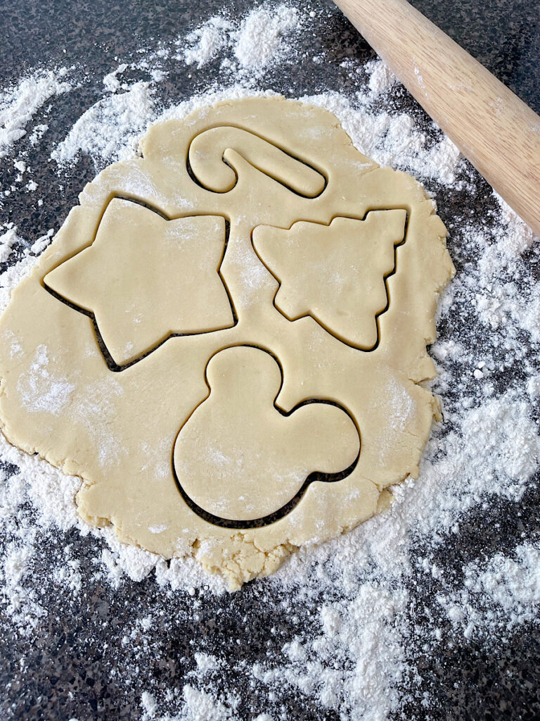 Shapes cut out of rolled sugar cookie dough.