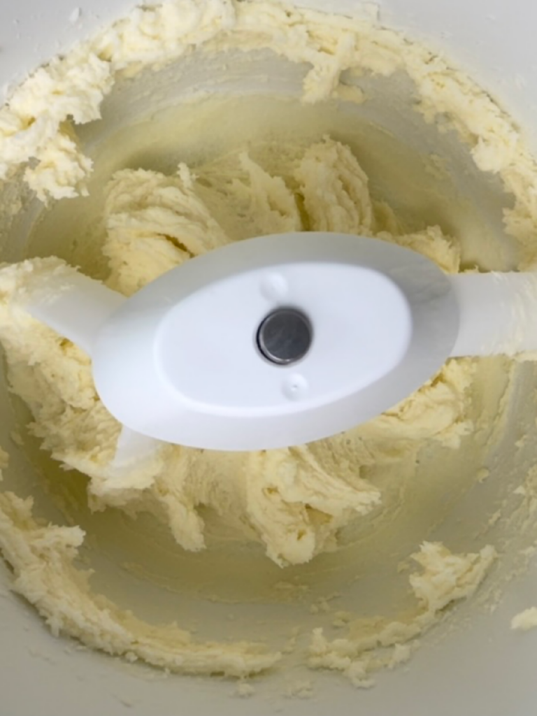 Butter and sugar mixed in a stand mixer.