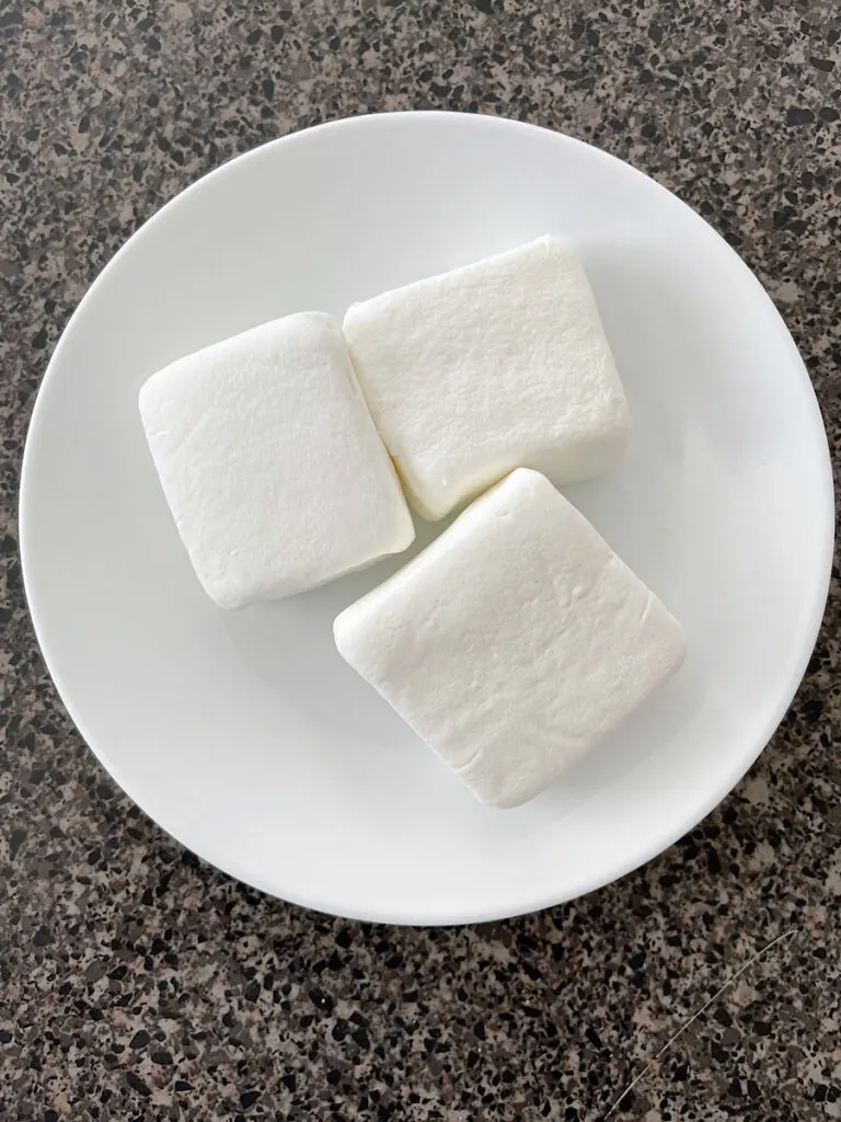 S'mores marshmallows on a white plate.