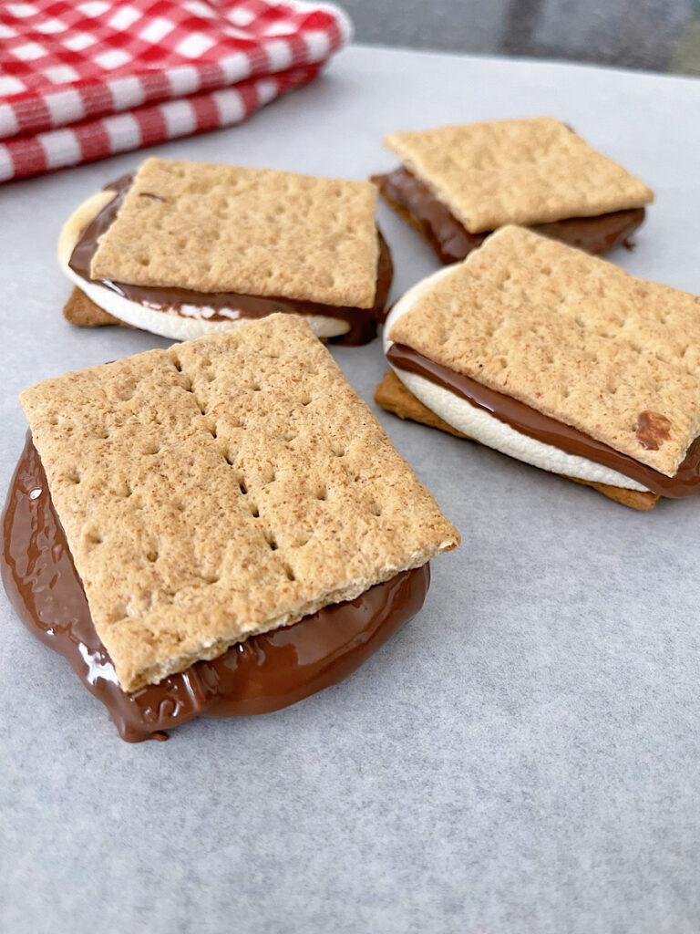 Four air fryer s'mores on parchment paper.