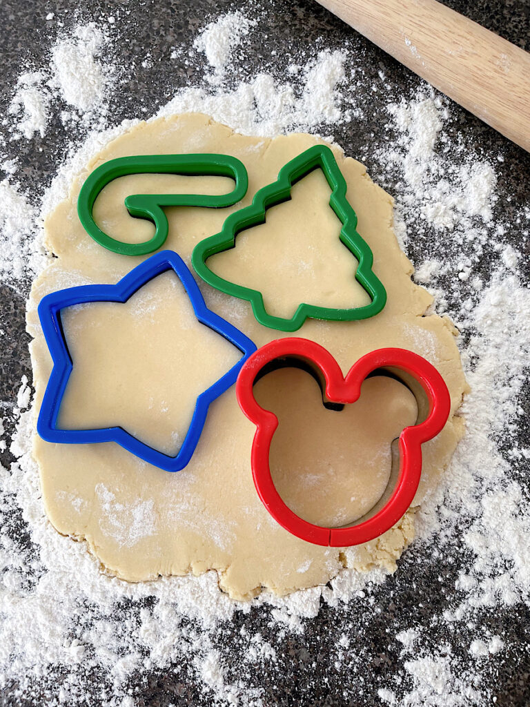 Cookie cutters pressed into rolled out sugar cookie dough.