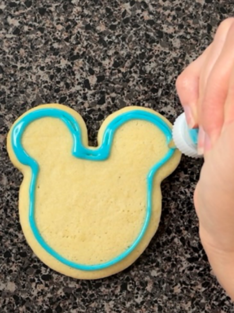 Sugar cookie icing piped onto a cookie.