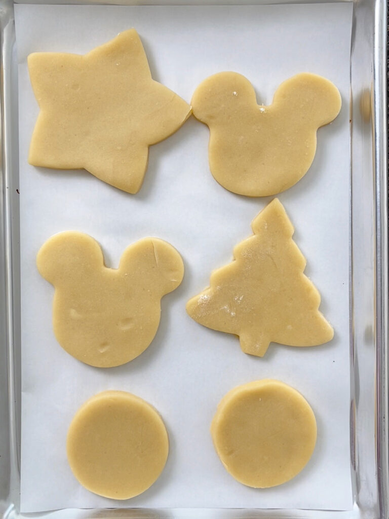 Cut out sugar dough on a parchment paper lined cookie sheet.