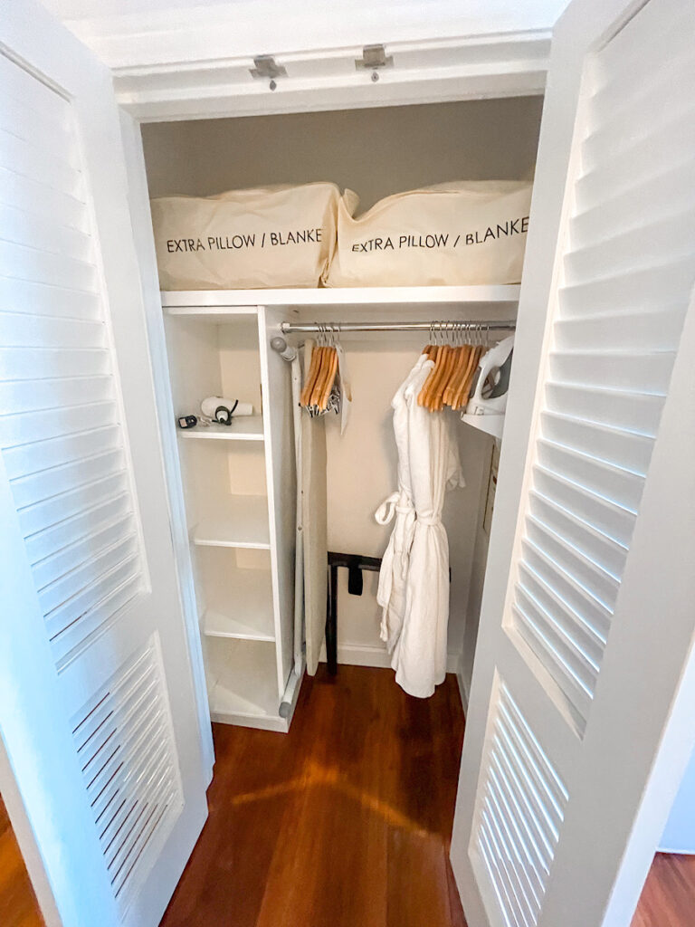 Hotel room closet with extra blankets and bath robes.