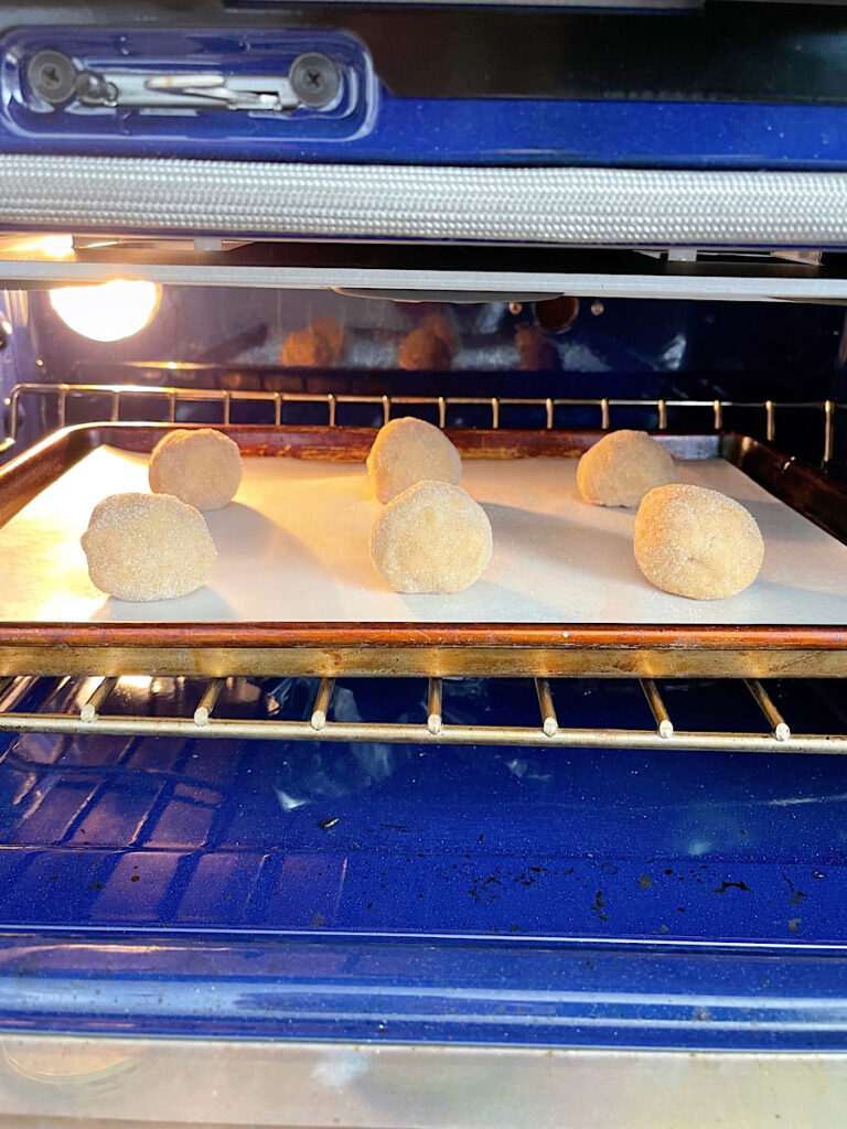 Snickerdoodles cooking in an oven.