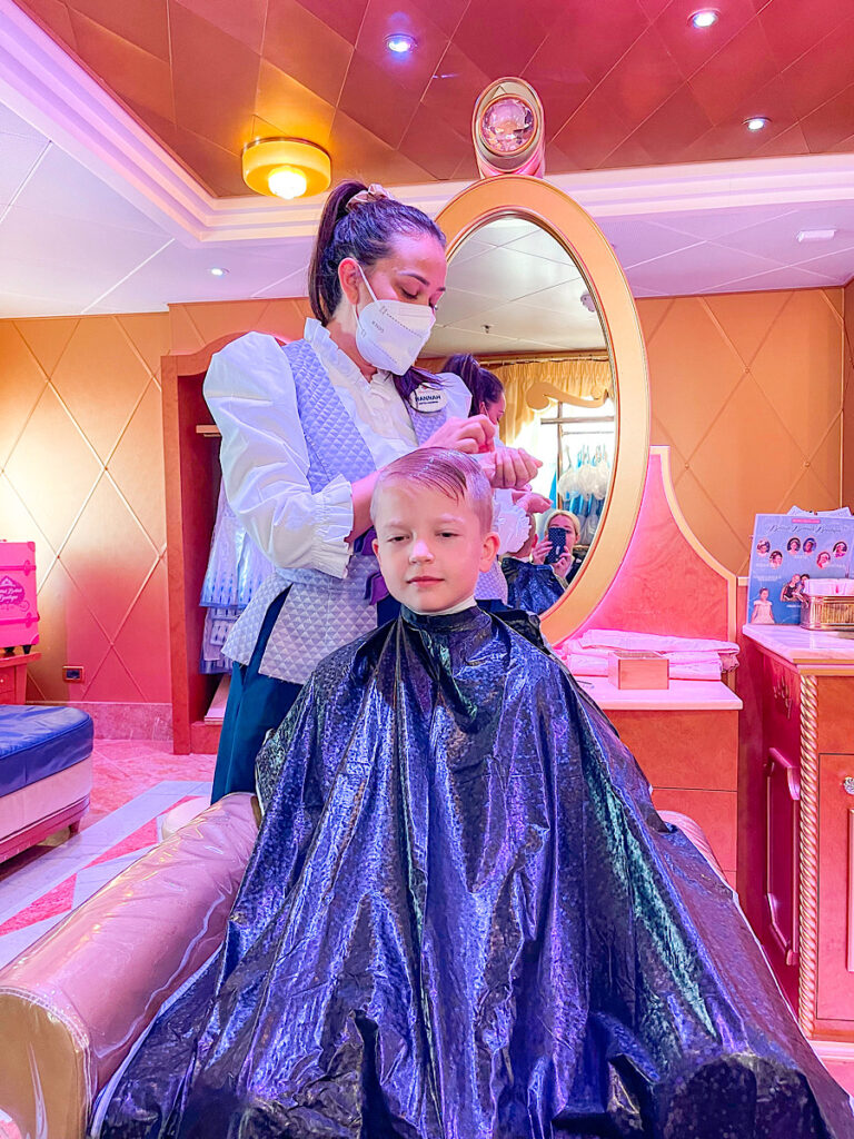 A boy getting his hair done in the Bibbidi Bobbidi Boutique on the Disney Magic.
