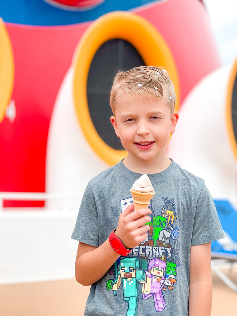 A boy eating an ice cream cone on the Disney Magic cruise ship.