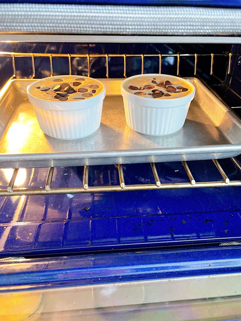 Two ramekins of TikTok Baked Oats in the oven.