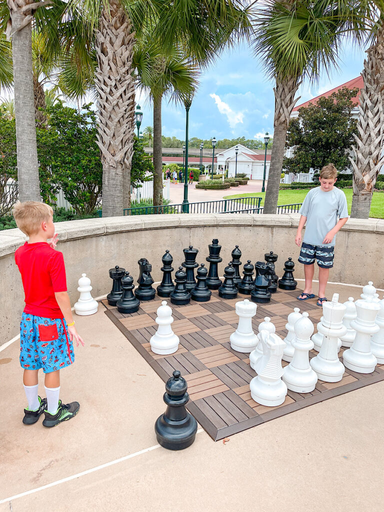 Two kids playing giant chess at Disney's Grand Floridian.