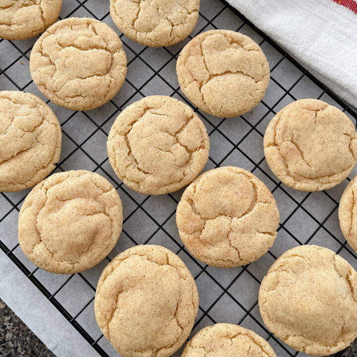 Snickerdoodle cookies on a wire rack.