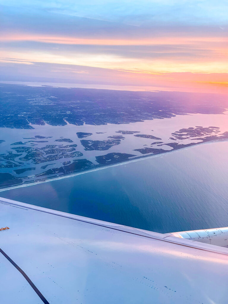 Looking out of a window on an air plane at dawn.