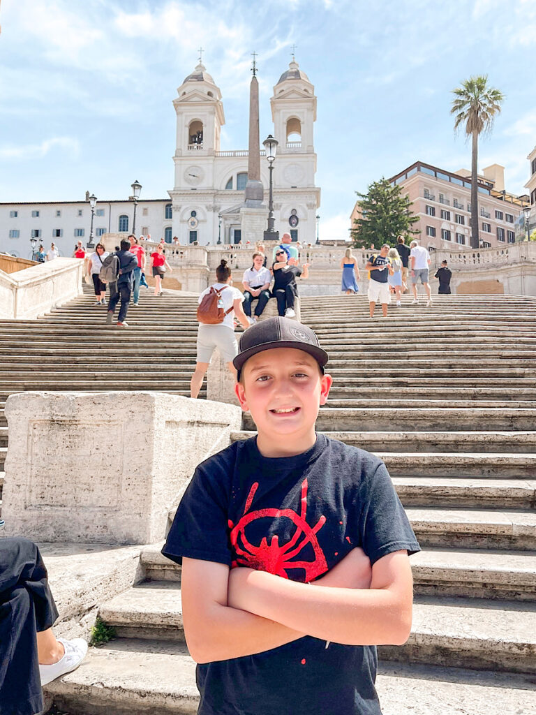 A child standing at the bottom of the Spanish Steps in Rome.