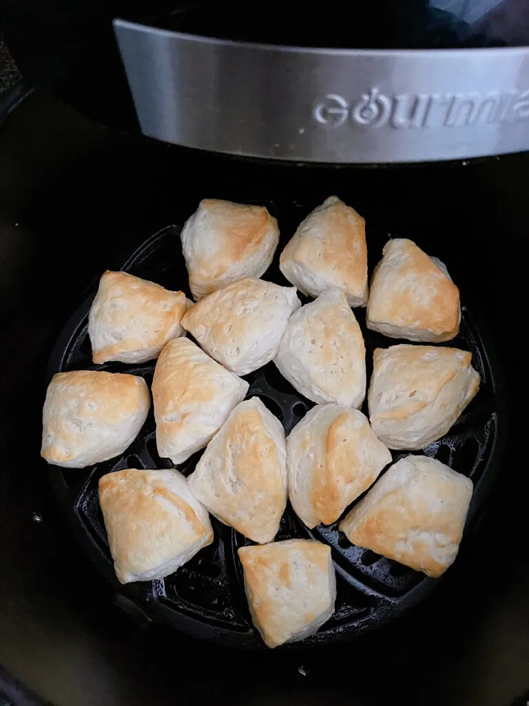 Biscuit dough in an air fryer to make donuts.