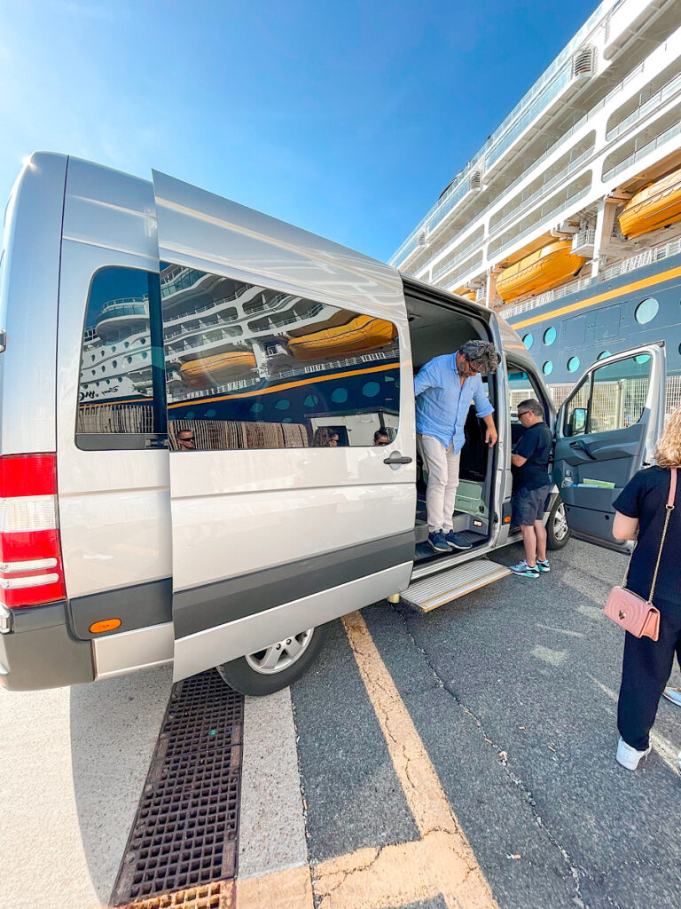 A tour van for Rome in front of the Disney Magic.