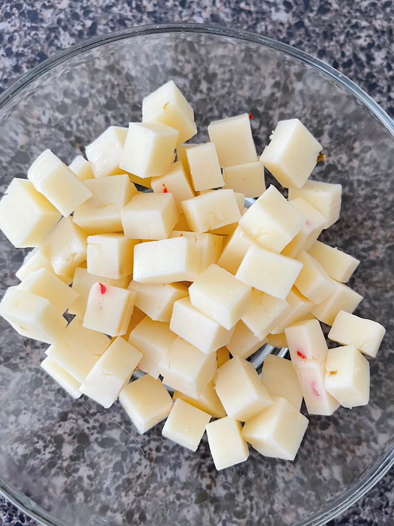 A bowl of cubed pepper jack cheese.