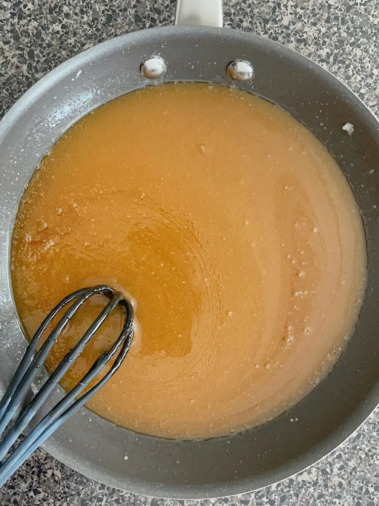 Sugar, butter, corn syrup, eggs, and vanilla mixed together in a sauce pan.