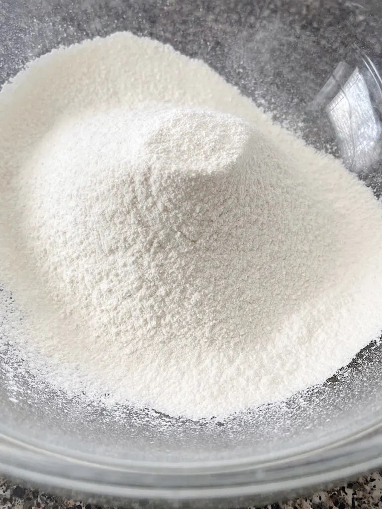 Sifted dry ingredients in a clear bowl to make pie crust.