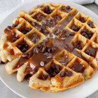 A Kodiak Protein Waffle drizzled with peanut butter syrup and mini chocolate chips.