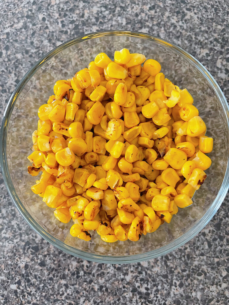 A bowl of roasted corn for barbecue chicken salad.