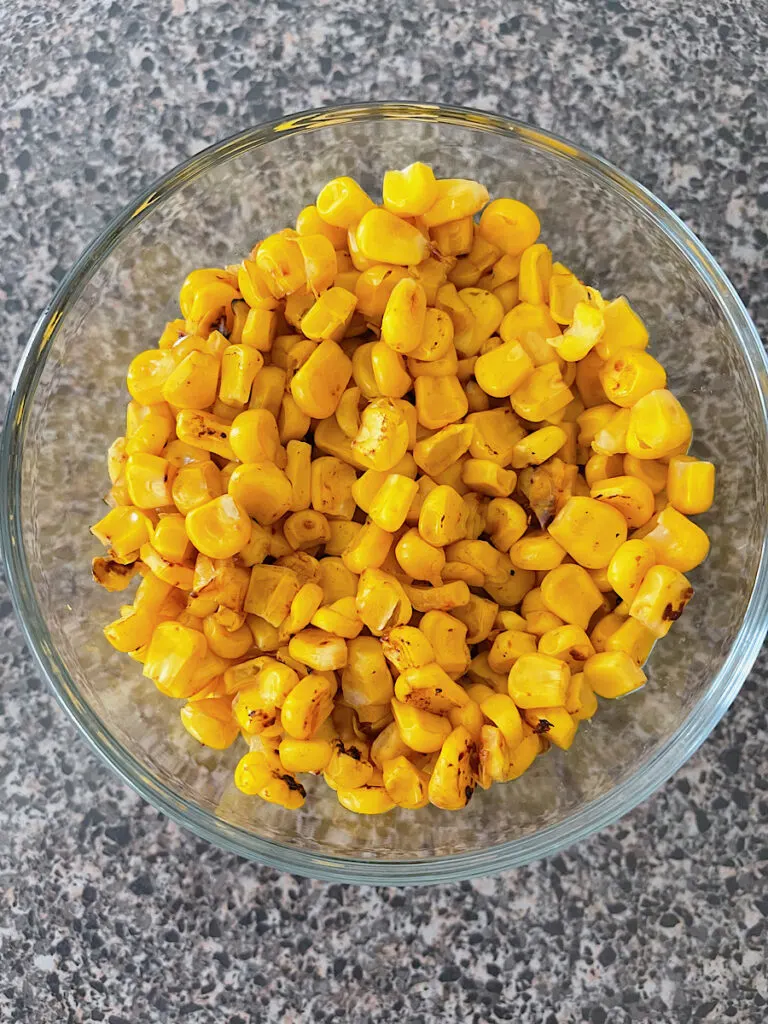 A bowl of roasted corn for barbecue chicken salad.