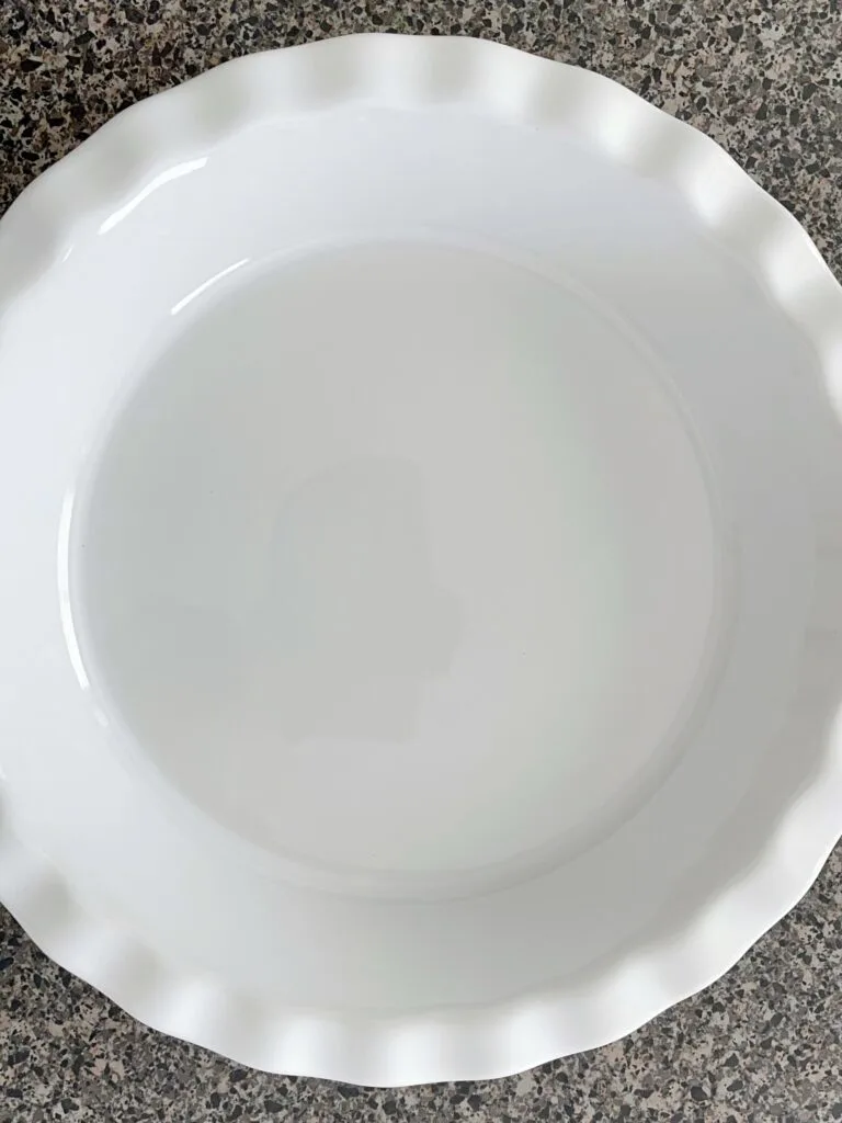 A lightly greased white pie plate.