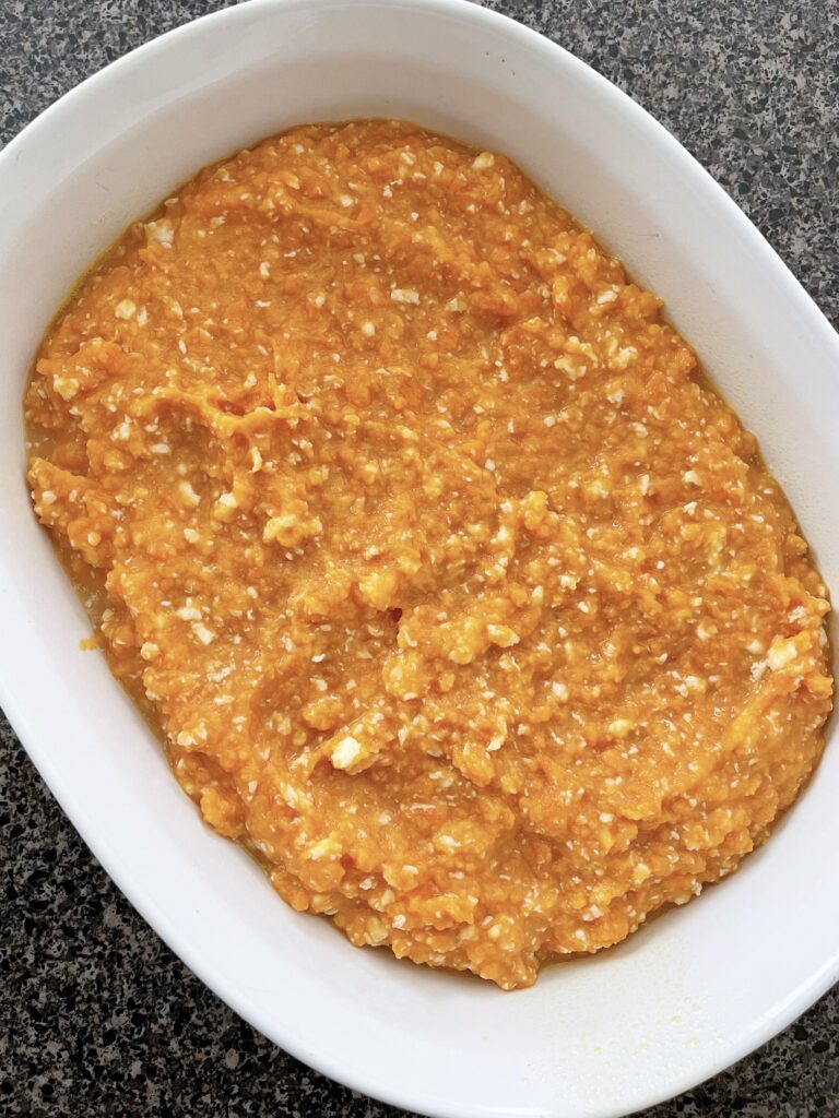 Mashed sweet potatoes in a white baking dish.