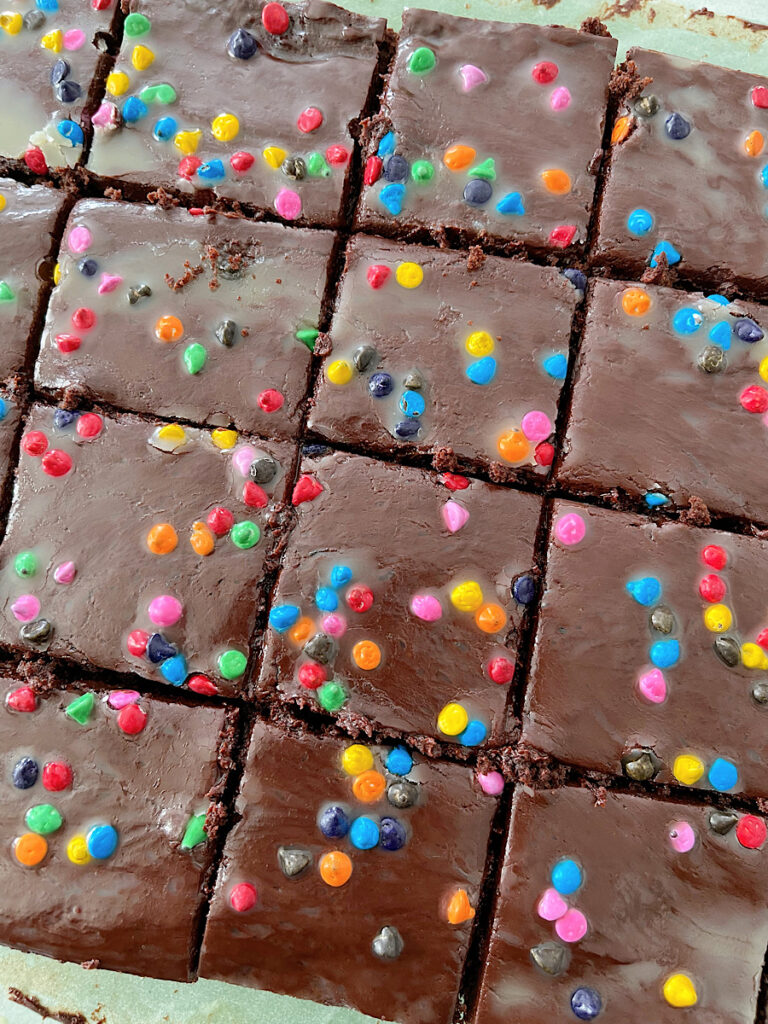 Homemade cosmic brownies on parchment paper.